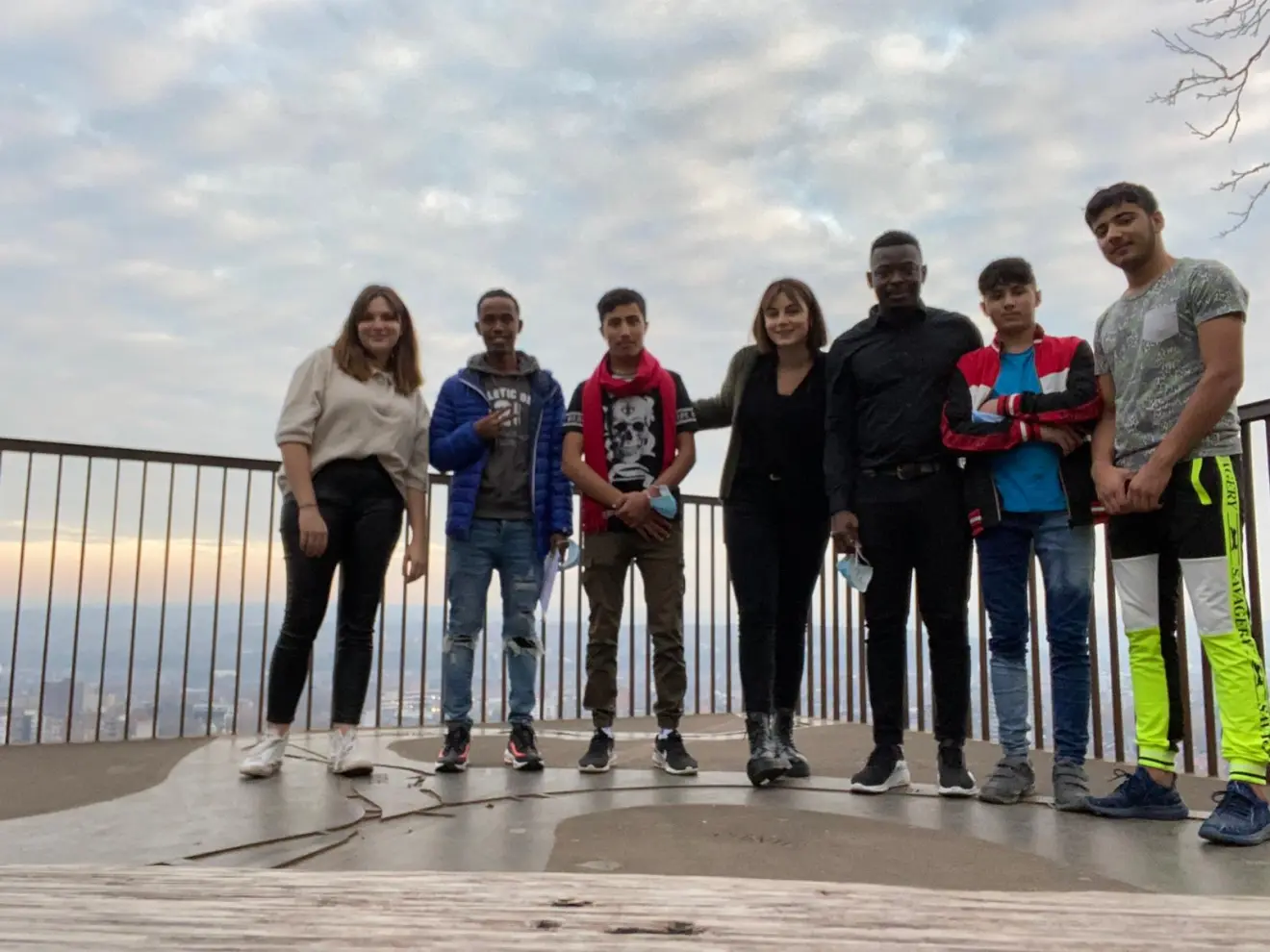A group of young people on a viewpoint overlooking Liege.
